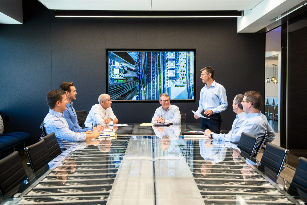 Corporate lifestyle photography in Los Angeles with Intrepid Investment Banking executives in a business meeting in the boardroom.