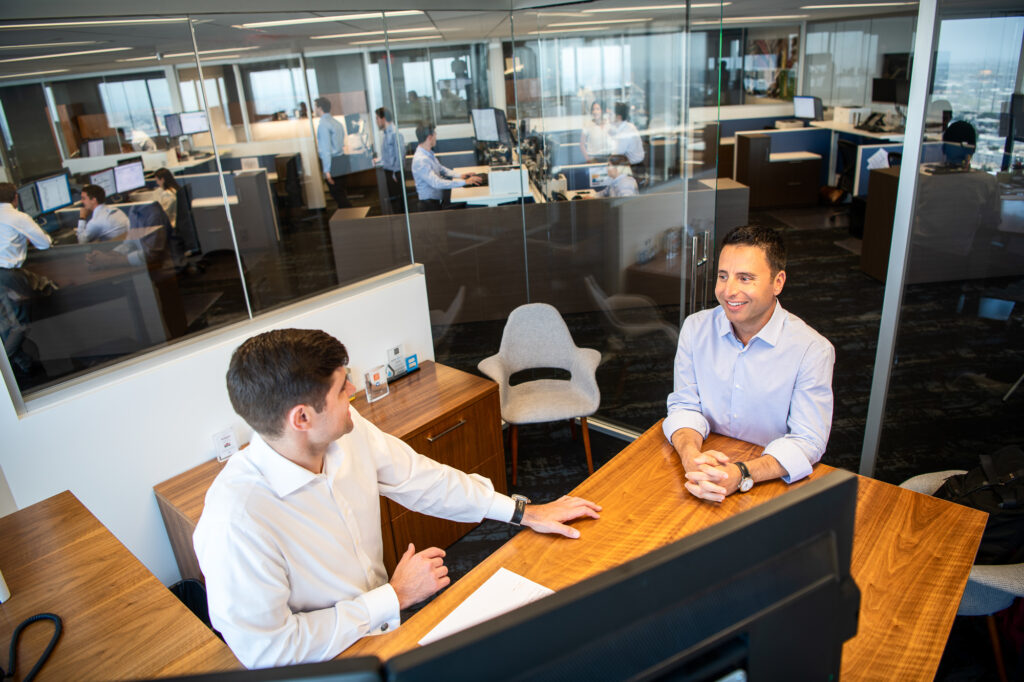 Banking executives meet in an office with glass walls in Santa Monica, Calif.