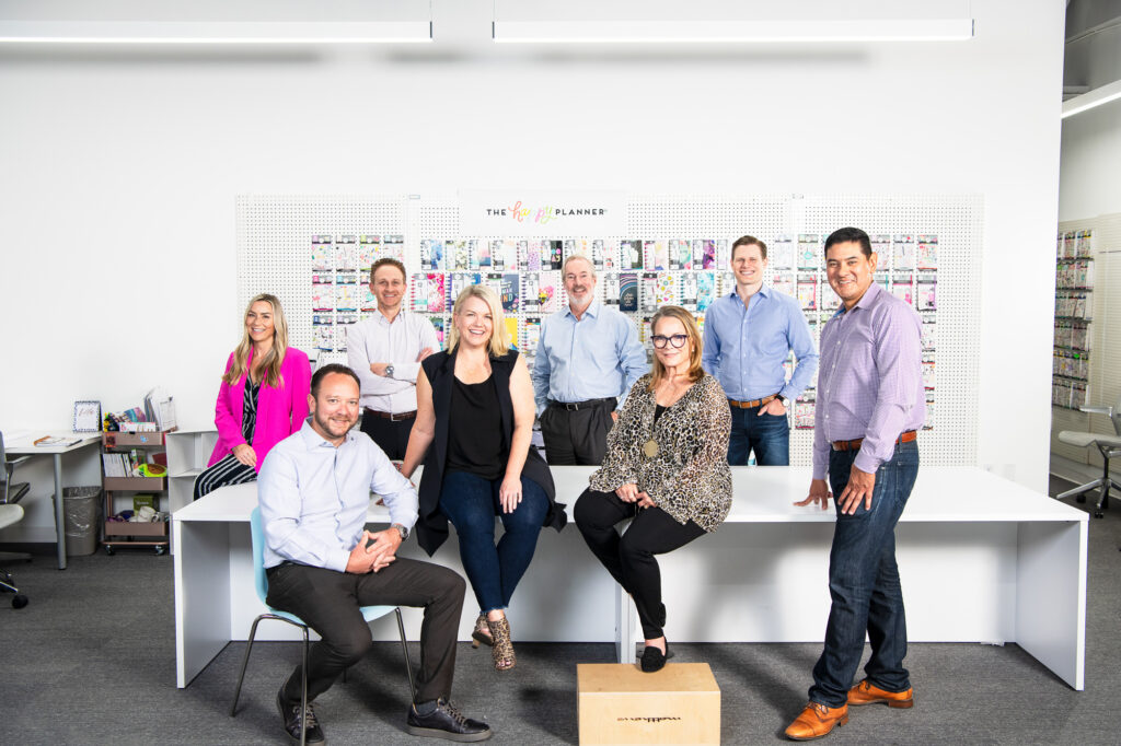 Lit group corporate environmental portrait in an office.