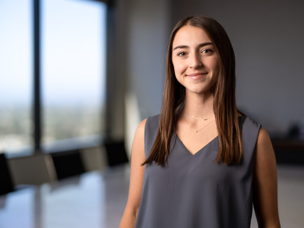 A young female banker poses for an environmental portrait in the office boardroom in Los Angeles.