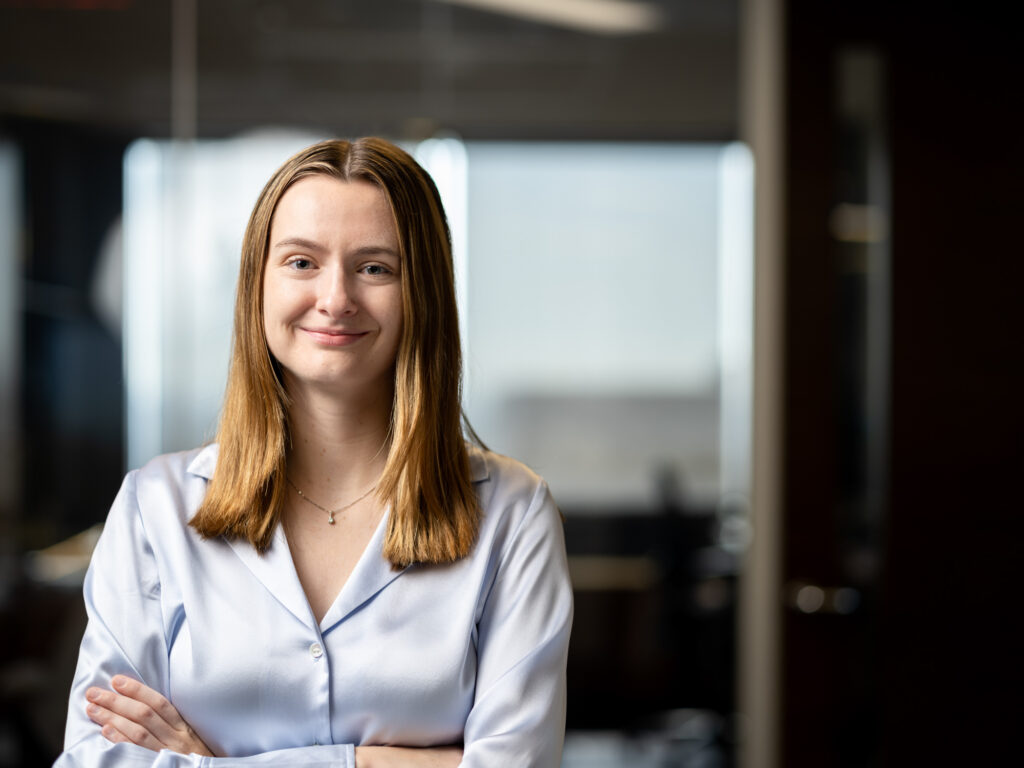 A female banking executive poses for an environmental portrait in a Los Angeles business office.