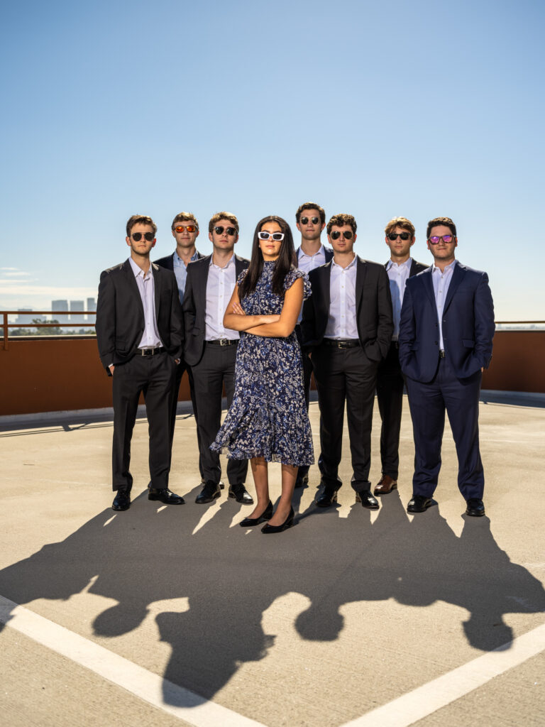 Humorous corporate group portrait of banking interns in sunglasses on a rooftop in Los Angeles.